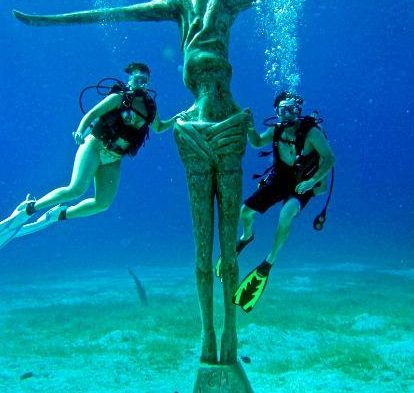 The Christ of Chankanaab with two divers
